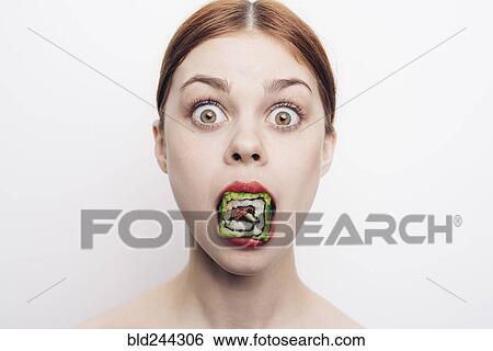 Stock Photograph - Caucasian woman with mouthful of sushi. Fotosearch