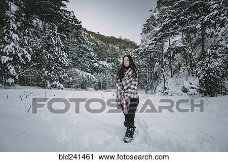 Caucasian woman wrapped in blanket in snowy forest View Large Photo Image Stock Image - Caucasian woman wrapped in blanket in snowy forest. Fotosearch