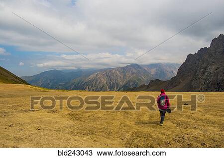 Stock Image - Caucasian women hiking in mountain landscape. Fotosearch