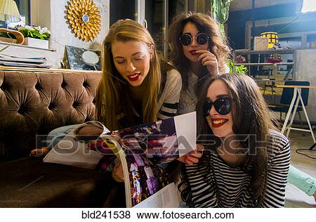Caucasian women reading magazine View Large Photo Image Stock Photo - Caucasian women reading magazine. Fotosearch