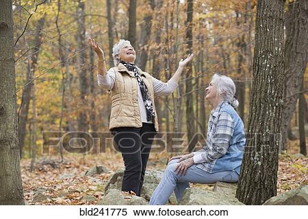 Stock Photography - Caucasian women smiling outdoors in autumn. Fotosearch