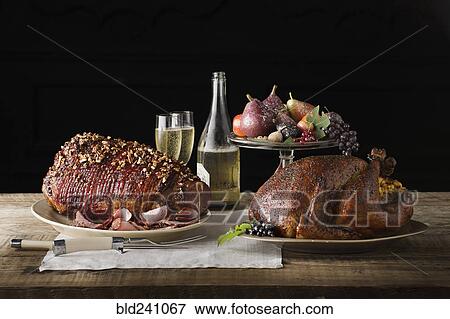 Stock Photo - "Champagne, fruit and meat on wooden table". Fotosearch