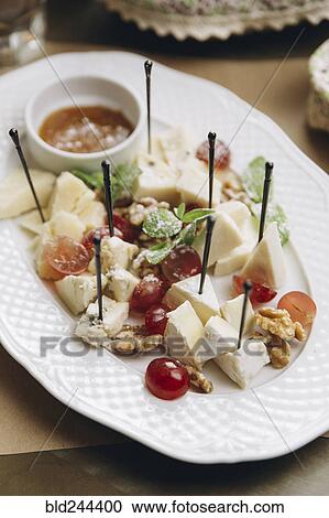 Stock Image - Cheese and fruit on plate. Fotosearch