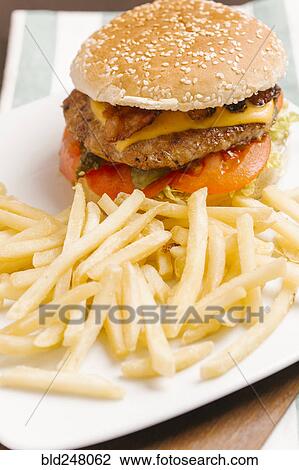 Stock Image - Cheeseburger with bacon and french fries. Fotosearch