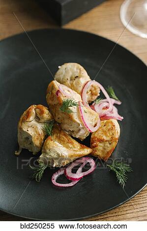Stock Photography - Chicken on plate with onions and garnish. Fotosearch