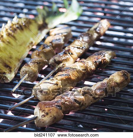 Chicken skewers cooking on grille View Large Photo Image Stock Photo - Chicken skewers cooking on grille. Fotosearch
