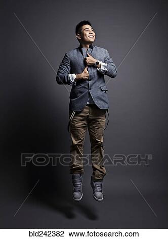 Chinese man wearing jacket and jumping View Large Photo Image Stock Image - Chinese man wearing jacket and jumping. Fotosearch
