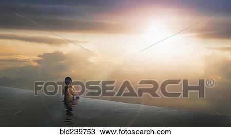 Chinese woman in infinity pool admiring sunset View Large Photo Image Stock Image - Chinese woman in infinity pool admiring sunset. Fotosearch