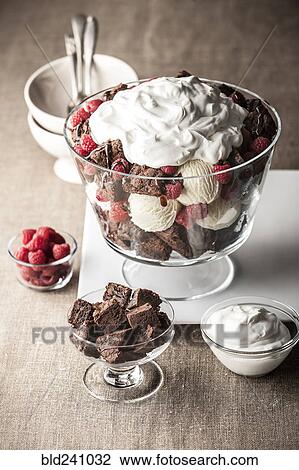 "Chocolate brownies with ice cream, whipped cream and raspberries" View Large Photo Image Stock Image - "Chocolate brownies with ice cream, whipped cream and raspberries". Fotosearch