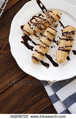 Chocolate syrup drizzled on pastries on plate View Large Photo Image Stock Image - Chocolate syrup drizzled on pastries on plate. Fotosearch
