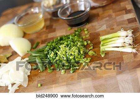 Stock Image - Chopped onions on cutting board. Fotosearch