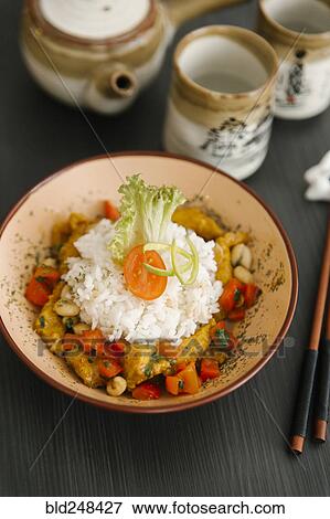 Chopsticks near bowl with rice View Large Photo Image Stock Photo - Chopsticks near bowl with rice. Fotosearch