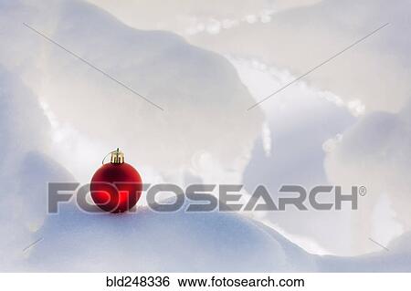 Stock Photograph - Christmas ornament on snow. Fotosearch