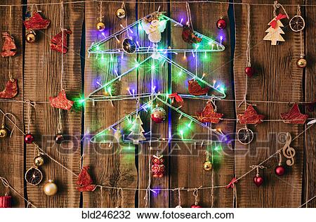 Christmas ornaments hanging on string on wood View Large Photo Image Stock Image - Christmas ornaments hanging on string on wood. Fotosearch