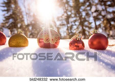Stock Image - Christmas ornaments in snow. Fotosearch