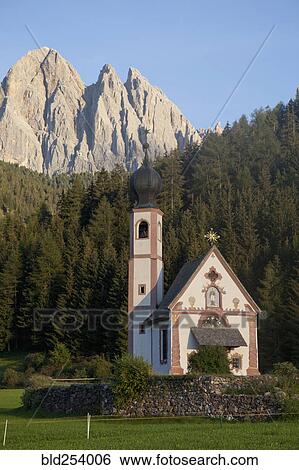Stock Photograph - Church in remote mountain landscape, Funes, Trentino Alto Adige, Italy. Fotosearch