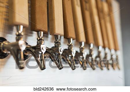 Stock Photograph - Close up of beer taps. Fotosearch