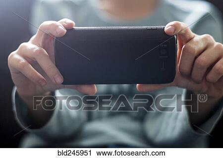 Close up of Caucasian boy photographing with cell phone View Large Photo Image Stock Image - Close up of Caucasian boy photographing with cell phone. Fotosearch