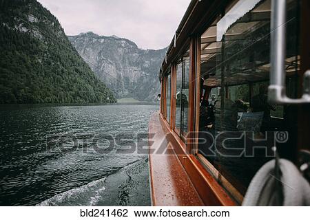 Close up of ferry on river near mountains View Large Photo Image Stock Image - Close up of ferry on river near mountains. Fotosearch