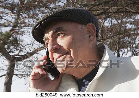 Close up of Hispanic man talking on cell phone View Large Photo Image Stock Photo - Close up of Hispanic man talking on cell phone. Fotosearch