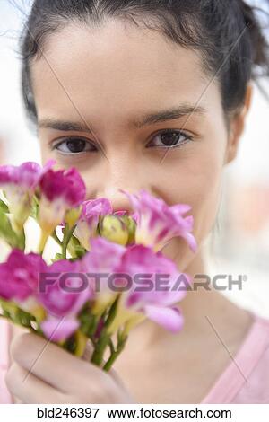 Close up of Hispanic woman holding flowers View Large Photo Image Stock Photo - Close up of Hispanic woman holding flowers. Fotosearch