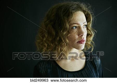 Stock Image - Close up of Mixed Race woman looking away. Fotosearch