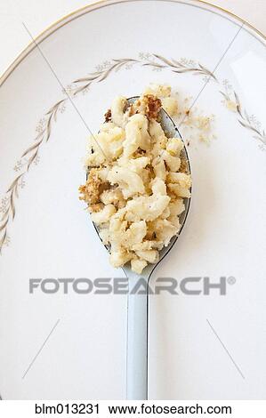 Stock Image - Close up of pasta on spoon. Fotosearch