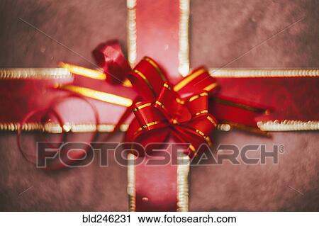 Close up of red bow on Christmas gift View Large Photo Image Stock Image - Close up of red bow on Christmas gift. Fotosearch