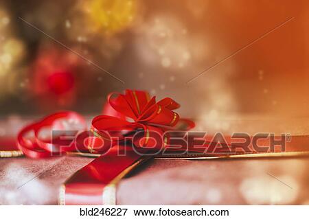 Close up of red bow on Christmas gift View Large Photo Image Stock Photo - Close up of red bow on Christmas gift. Fotosearch