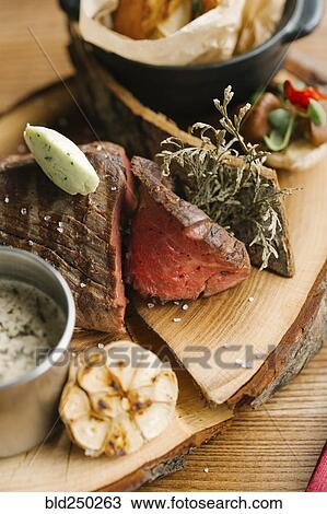 Close up of sliced meat on tree slice plate View Large Photo Image Stock Image - Close up of sliced meat on tree slice plate. Fotosearch