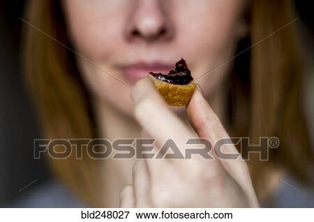 Close up of woman holding bread with jam View Large Photo Image Stock Photo - Close up of woman holding bread with jam. Fotosearch