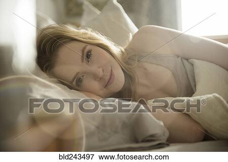 Stock Photo - Close up of woman laying in bed. Fotosearch