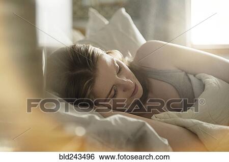 Close up of woman sleeping in bed View Large Photo Image Stock Photograph - Close up of woman sleeping in bed. Fotosearch