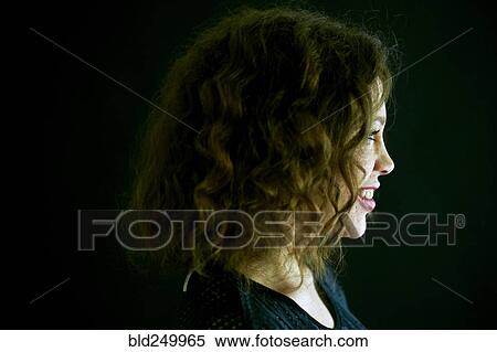 Stock Photography - Close up profile of smiling Mixed Race woman. Fotosearch
