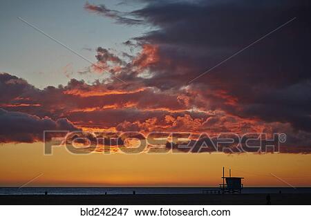 Clouds illuminated in colorful sunset sky View Large Photo Image Stock Photo - Clouds illuminated in colorful sunset sky. Fotosearch