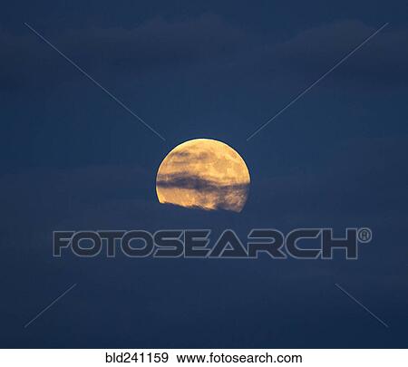 Clouds in sky in front of full moon View Large Photo Image Stock Photo - Clouds in sky in front of full moon. Fotosearch