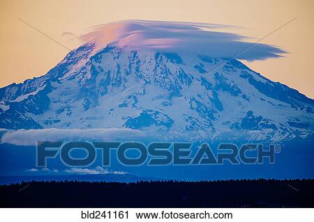 Stock Image - Clouds over snowy mountain. Fotosearch