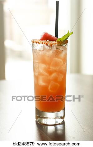 Cocktail in glass with straw View Large Photo Image Stock Photo - Cocktail in glass with straw. Fotosearch
