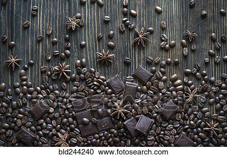 Stock Image - Cocoa beans and chocolate bars on wooden table. Fotosearch