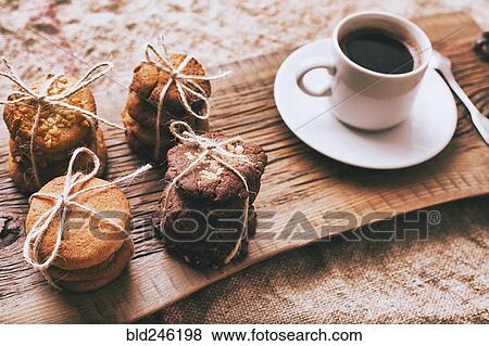 Coffee and bundles of cookies on wooden tray View Large Photo Image Stock Photo - Coffee and bundles of cookies on wooden tray. Fotosearch