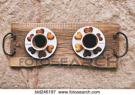Coffee and heart-shape cookies on wooden tray View Large Photo Image Stock Photo - Coffee and heart-shape cookies on wooden tray. Fotosearch