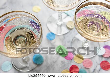 Stock Image - Confetti near glasses of champagne. Fotosearch