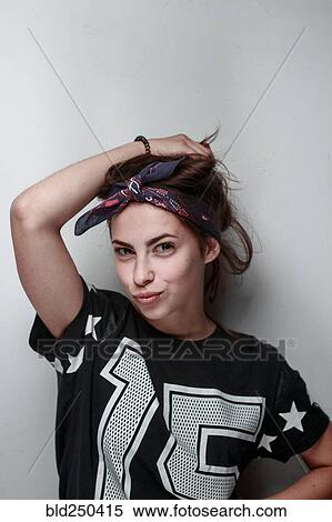 Stock Photography - Confident Caucasian woman wearing football jersey. Fotosearch