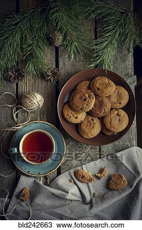 Cookies and tea on wooden table with pine cones View Large Photo Image Stock Image - Cookies and tea on wooden table with pine cones. Fotosearch
