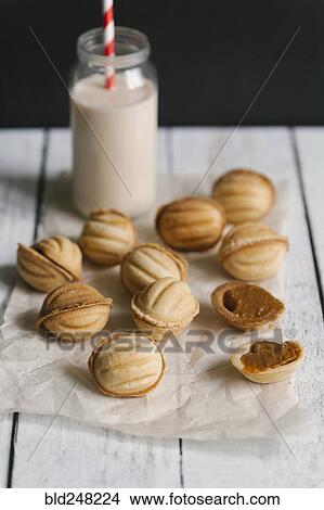 Cookies on wax paper with milk View Large Photo Image Picture - Cookies on wax paper with milk. Fotosearch