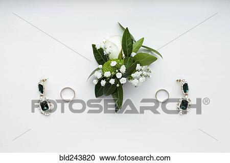 Stock Image - "Corsage, earrings and wedding rings". Fotosearch