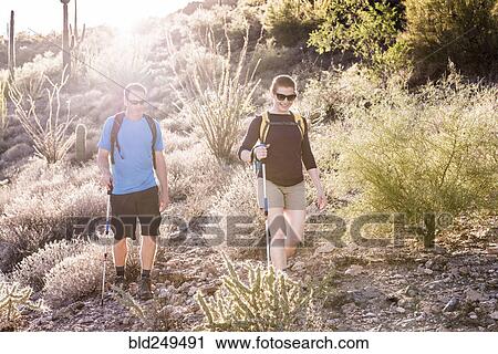 Stock Image - Couple hiking in desert. Fotosearch