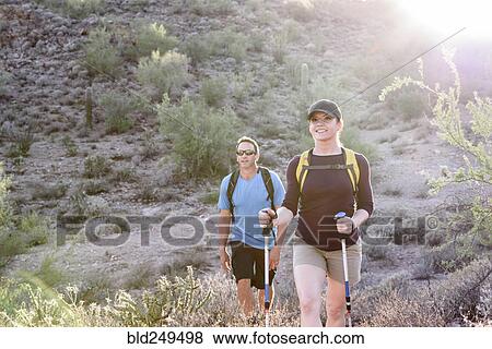 Stock Photo - Couple hiking in desert. Fotosearch