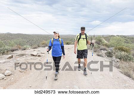 Couple hiking on rocky path in desert View Large Photo Image Stock Image - Couple hiking on rocky path in desert. Fotosearch