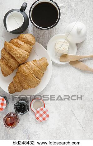 Stock Image - Croissants on plate with coffee and jam. Fotosearch